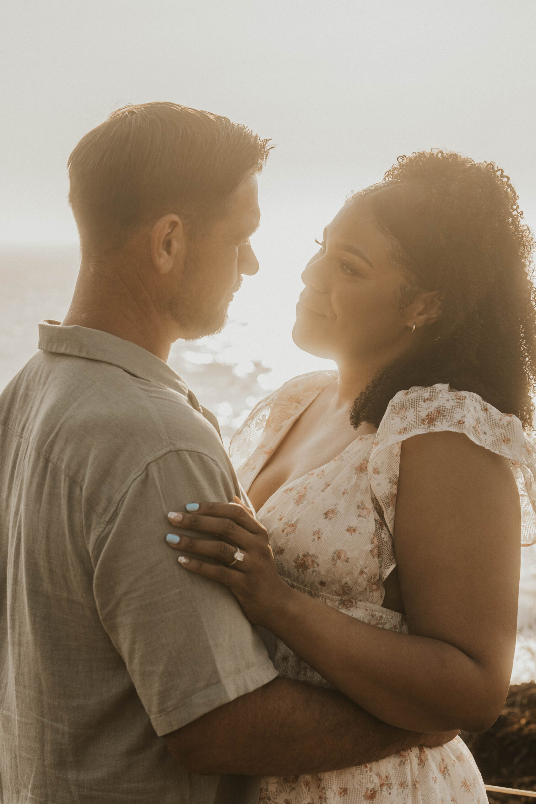 Couple standing on the beach in Big Sur during golden hour engagement session